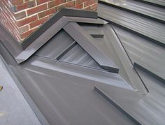 the corner of a building with metal roofing