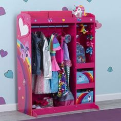 a pink children's wardrobe with lots of clothes