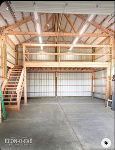 an empty garage with stairs leading up to the second floor