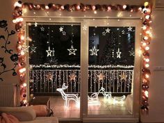 an open window with christmas lights on the outside