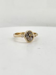 Golden quartz is prized for its unique and individual crystal patterns, and this particular ring was made and designed by Arizona based artist James Hawkes.  All set into 14k yellow gold, and accented with two diamond rounds, this ring has a delicate look but with plenty of metal integrity for everyday wear.  Currently this ring is a size 6.25, but please inquire about having it sized to you! Fine Jewelry In Yellow Gold With Natural Inclusions, Elegant Anniversary Rings With Natural Inclusions, Yellow Gold Jewelry With Natural Inclusions For Anniversary, Unique Gold Oval Diamond Ring, Timeless Gold Diamond Ring With Accent Stones, Gold Oval Diamond Ring With Unique Style, Unique Oval Diamond Ring With Accents, Unique Oval Yellow Gold Diamond Ring, Luxury Jewelry With Natural Inclusions For Anniversary