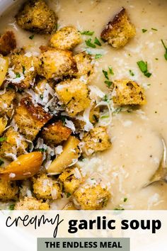 creamy garlic soup in a white bowl with parmesan cheese and bread croutons