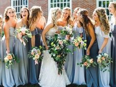 a group of women standing next to each other in front of a building with flowers