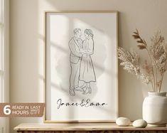 a drawing of two people embracing each other on a shelf next to a vase and potted plant