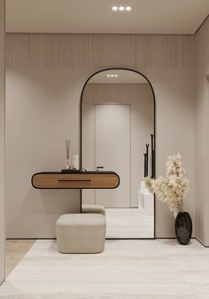 a bathroom with a mirror, stool and vase on the floor in front of it