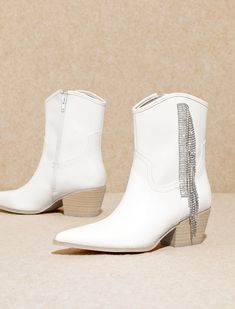 Step into a world of elegance and flair with our White Fringe Rhinestone Boots. These captivating boots seamlessly marry classic sophistication with a touch of bohemian charm, featuring delicate fringe detailing that adds a playful yet refined dimension to your ensemble. Adorned with sparkling rhinestones, these boots become a dazzling focal point, elevating your style to new heights. True to size White Rhinestone Boots For Fall, Winter Boots With Rhinestone Fringe, Elegant Embellished White Boots, Glamorous Winter Boots With Rhinestone Fringe, Elegant Fringe Boots For Party, Glamorous White Embellished Boots, Elegant Fringe Party Boots, Glamorous White Boots With Rhinestones, Glamorous White Rhinestone Boots