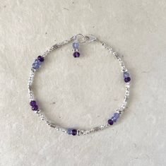 Amethyst, tanzanite, Karen Hill Tribe Thai silver beaded bracelet with dangle 7 inches is average size Amethyst metaphysical properties: Spiritual awareness, inner peace, healing of body, mind & soul, positive transformation, balance, relieves stress Tanzanite metaphysical properties: Compassion, love, helps overcome fears, rebuilds trust, faith, patience, communication, happiness, harmony Please note Gemstones are works of nature, therefore, can have differences in color and may have inclus Spiritual Amethyst Beaded Birthstone Bracelet, Adjustable Amethyst Beaded Bracelets With Birthstone, Spiritual Purple Sterling Silver Bracelet, Spiritual Purple Birthstone Bracelets, Silver Wedding Bracelet, Apatite Jewelry, Tanzanite Bracelet, Sundance Style, Dainty Gold Bracelet