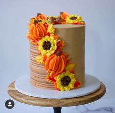 a cake decorated with flowers on top of a table