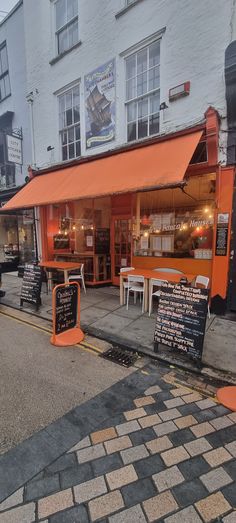 an orange awning on the outside of a restaurant