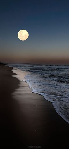 the moon is setting over the ocean and beach