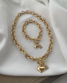 Add a bold touch to your accessory collection with this stunning 2-piece set, featuring a gold-plated vintage thick chain necklace and bracelet. Each piece is designed with a special lock system and a filled heart charm, offering a perfect blend of elegance and statement style. ✨ Gold-plated thick chain for a vintage-inspired, luxurious look 🗝️ Special lock system for secure and stylish wear 💖 Filled heart charm adds a romantic and elegant touch Includes both a necklace and bracelet for a comp Thick Chain Necklace, Heart Charm Necklace, Bracelet And Necklace, Gold Charm Bracelet, Necklace And Bracelet, Christmas 2024, Gold Charm, Charm Bracelets, Statement Jewelry