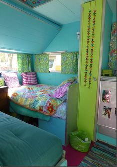 a bedroom with two beds and a green wall