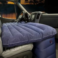 an inflatable car bed is placed inside the back seat of a pickup truck