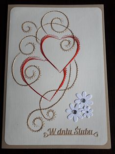 a card with a heart and flowers on it