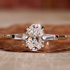 an oval diamond engagement ring with baguettes on the side