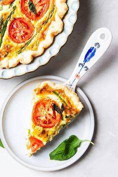 a slice of quiche on a plate next to a pie dish with a serving utensil