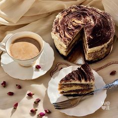 a piece of cake on a plate next to a cup of coffee