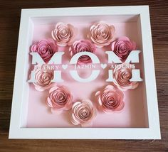 pink paper flowers arranged in the shape of a mom's heart