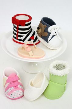 several pairs of baby shoes are stacked on top of each other in the shape of three tiers