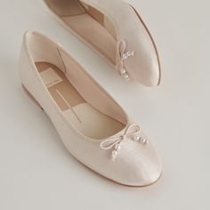 We added the most feminine gemstone to the most feminine ballet flat. In an ivory hue, CACY PEARL’s delicate bow is adorned with dainty pearls. This flat is ideal for the laid-back, comfort seeking bride, but she styles great with denim and floral dresses too. Textile Upper Recycled Synthetic Outsole Textile Lining Water-based Leather Alternative Sock 0.4" Heel Height Imported Ballet Sandals, Wedding Ballerina Flats, Beautiful Ballet Flats, Ballet Flat Wedding Shoes, Beaded Wedding Shoes, Luxury Feminine Formal Ballet Flats, White Satin Wedding Shoes, Ballet Flats Wedding, Heeled Ballet Pumps