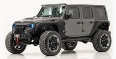 a black jeep is parked in a white room