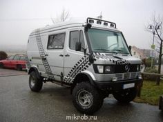 a white van with black and white designs on it's front tire rims