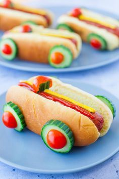 hotdogs with ketchup, mustard and avocado on blue plates