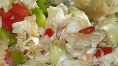 a salad with onions, peppers, and other vegetables in it is ready to be eaten