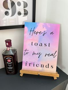 there's a toast to my real friends sign next to a bottle of booze