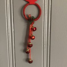 a door hanger with bells hanging from it's side