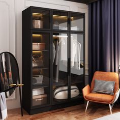 an orange chair sits in front of a black cabinet with glass doors and clothes on it