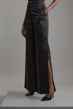 Delivering A Combination Of Dressed-Down Glamour And Statement Style, Discover Collections: 06 Partywear. A New Addition To A Tailored Essentials Collection, These Trousers Are Tailor-Made With An Easy To Style, Sleek Design, Split Detailing, And A Comfortable Wide Fit. The Satin Fabric Makes For A Unique Take On A Formal Outer Layer. Style This Piece With A Shirt And Heels For A Look That Goes Seamlessly From Occasion Nights To Date Nights. Structured Viscose Satin Tailored Wide Leg Trousers Hi Elegant Evening Pantsuit With Trousers, Sleek Leather Pants For Evening, Classic Silk Wide Leg Pants For Evening, Fitted Dress Trousers For Party, Elegant Full-length Silk Pants, Sleek Silk Formal Pants, Sleek Evening Dress Pants, Party Bottoms With Side Slits, Sleek Tailored Dress Pants For Party