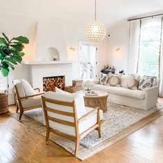 a living room filled with furniture and a fire place in the middle of a room