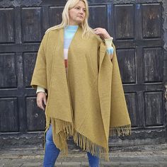 Timeless and versatile  poncho for freely moving is made from merino wool  Ideal for all seasons.  This is  extra warm poncho looks fantastic in the town or country  COMPOSITION: 80% merino wool 20% nylon (for extra durability) Measurements are as follows:  55  inches in width (or 140cm) and  39 inches  (100cm) in length (including the fringes).  They are One size fits most. CARE INSTRUCTIONS: dry clean or hand wash in cold water. An excellent wool poncho for indoor and outdoor use. Protects aga Wool Cape Shawl For Fall, Oversized Fringe Shawl For Winter, Oversized Fringed Shawl For Winter, Winter Fringe Cape Outerwear, Oversized Fringe Cape Poncho, Fall Wool Cape Shawl, Oversized Fringe Cape For Fall, Winter Wool Cape Shawl, Wool Cape Shawl For Winter