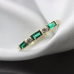 "Handmade by an inspired jewelry artist team with decades of experience in the craft of jewelry making. Each gemstone, each diamond is carefully picked. Using only the finest raw materials and the highest industry standard in manufacturing, design and finish. Perfect Baguette Emerald and round diamonds stacking ring in a vintage milgrain setting Ideal for stacking with your other rings, Adds to every stack but doesn't steal the show. Rounded inner edges for comfort, You will never want to take i Elegant Stackable Emerald Ring For Anniversary, Classic Stackable Birthstone Ring With Emerald Cut, Elegant Stackable Half Eternity Rings With May Birthstone, Elegant Stackable Half Eternity Rings For May Birthstone, Half Eternity Baguette Cut Emerald Jewelry, Baguette Cut Emerald Half Eternity Jewelry, Elegant Diamond Stackable Rings For May Birthstone, Fine Jewelry Emerald Half Eternity Stackable Rings, Emerald Half Eternity Stackable Rings