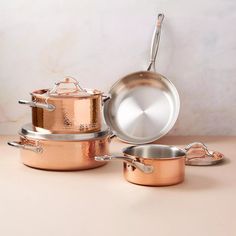 an assortment of pots and pans on a table