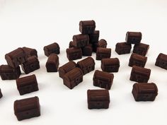 a pile of chocolate pieces sitting on top of a white table next to each other