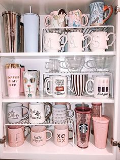 a shelf filled with lots of cups and mugs on top of eachother