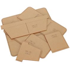 six pieces of brown paper with stitching on them