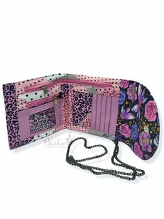 a purse with a chain hanging from it's side and an open wallet on the other side