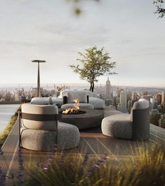 an outdoor living area with couches, tables and fire pit in front of a cityscape