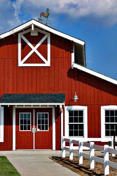 a red barn with white trim and windows