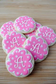 pink decorated cookies with white polka dots and monogrammed letters