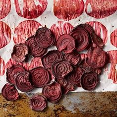 red beets cut up and placed on top of a piece of paper with holes in the middle