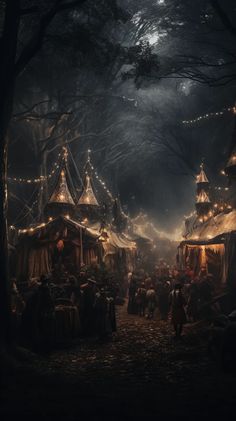 a group of tents in the middle of a forest at night with lights on them