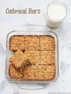 oatmeal bars in a glass dish next to a glass of milk