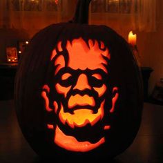 a carved pumpkin with the face of abraham lincoln on it's face, lit by candles