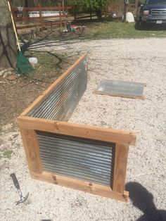 a wooden box sitting on top of a dirt field