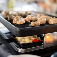 some food is cooking on top of a black grill and it looks like they are being cooked