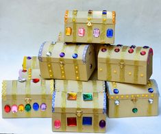 there are many boxes that have been made out of cardboard and decorated with jeweled decorations